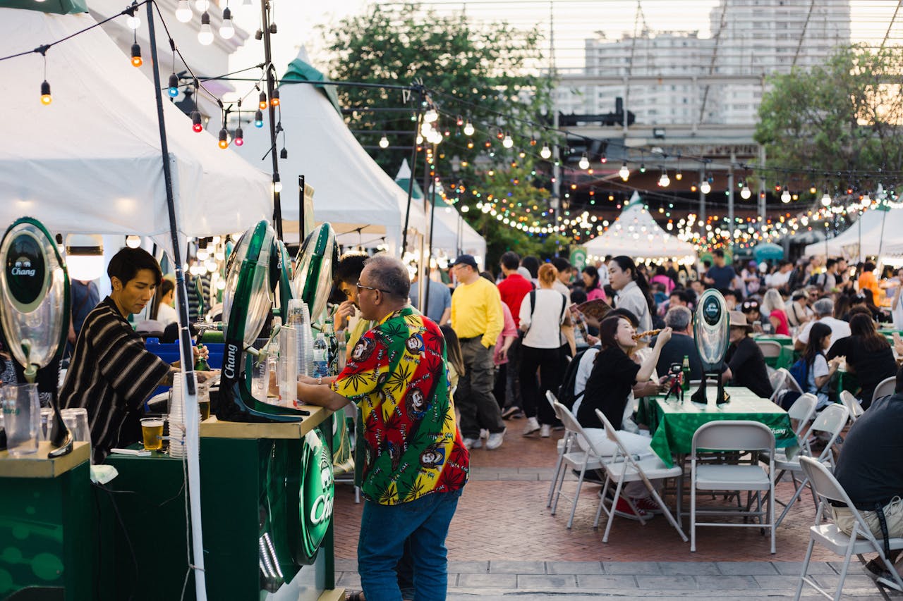 gallery-4 Lively outdoor food festival in Bangkok with bustling crowd and colorful lights.