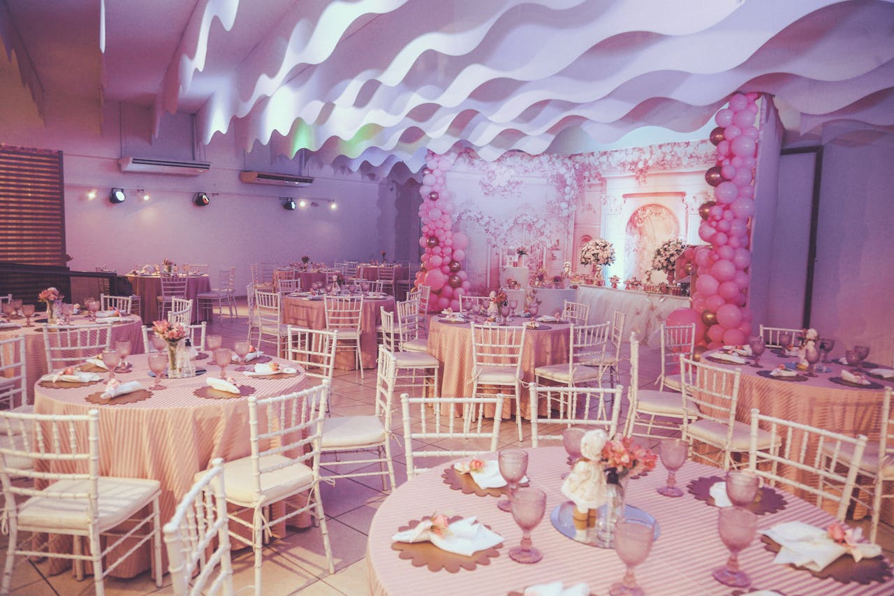 gallery-3 Beautiful pink-themed event setup with balloons and decorated tables.