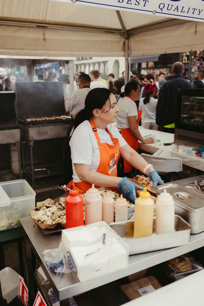 Street food vendor preparing dishes at an outdoor market in Dublin, Ireland.