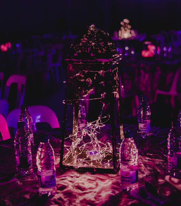 why-choose-us Elegant night event with decorative lights and a colorful illuminated centerpiece on a table.